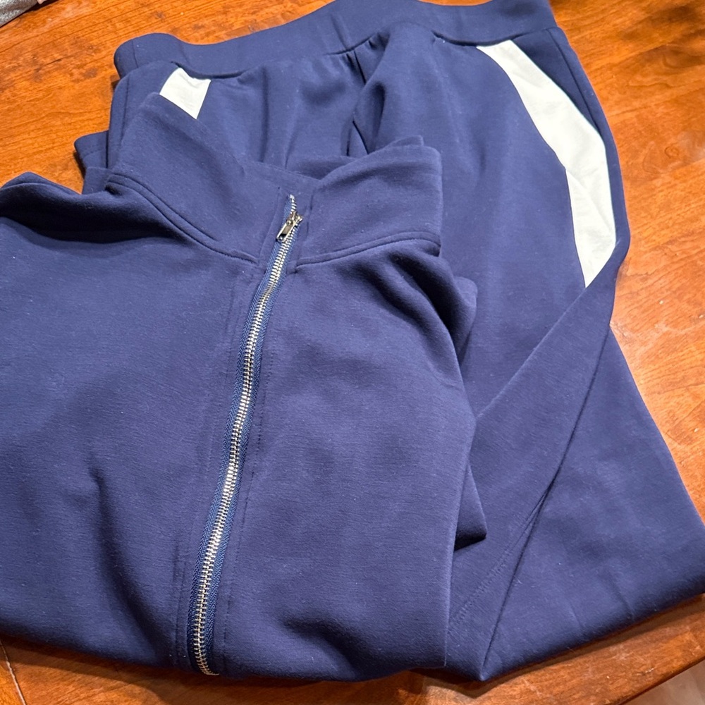 Navy Blue Tracksuit with White Accents. Full zipper jacket. Pants with pockets.